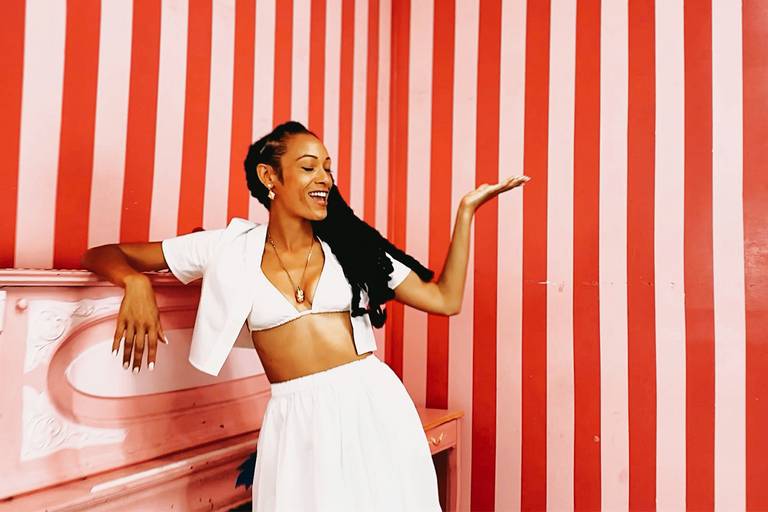 Tuff Like Iron in front of a striped wall