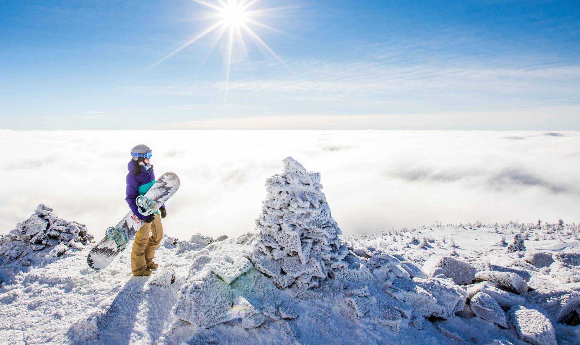 Snowboarder on summit with inversion