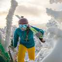 female skier carrying skis