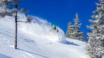 powder skier on bluebird day