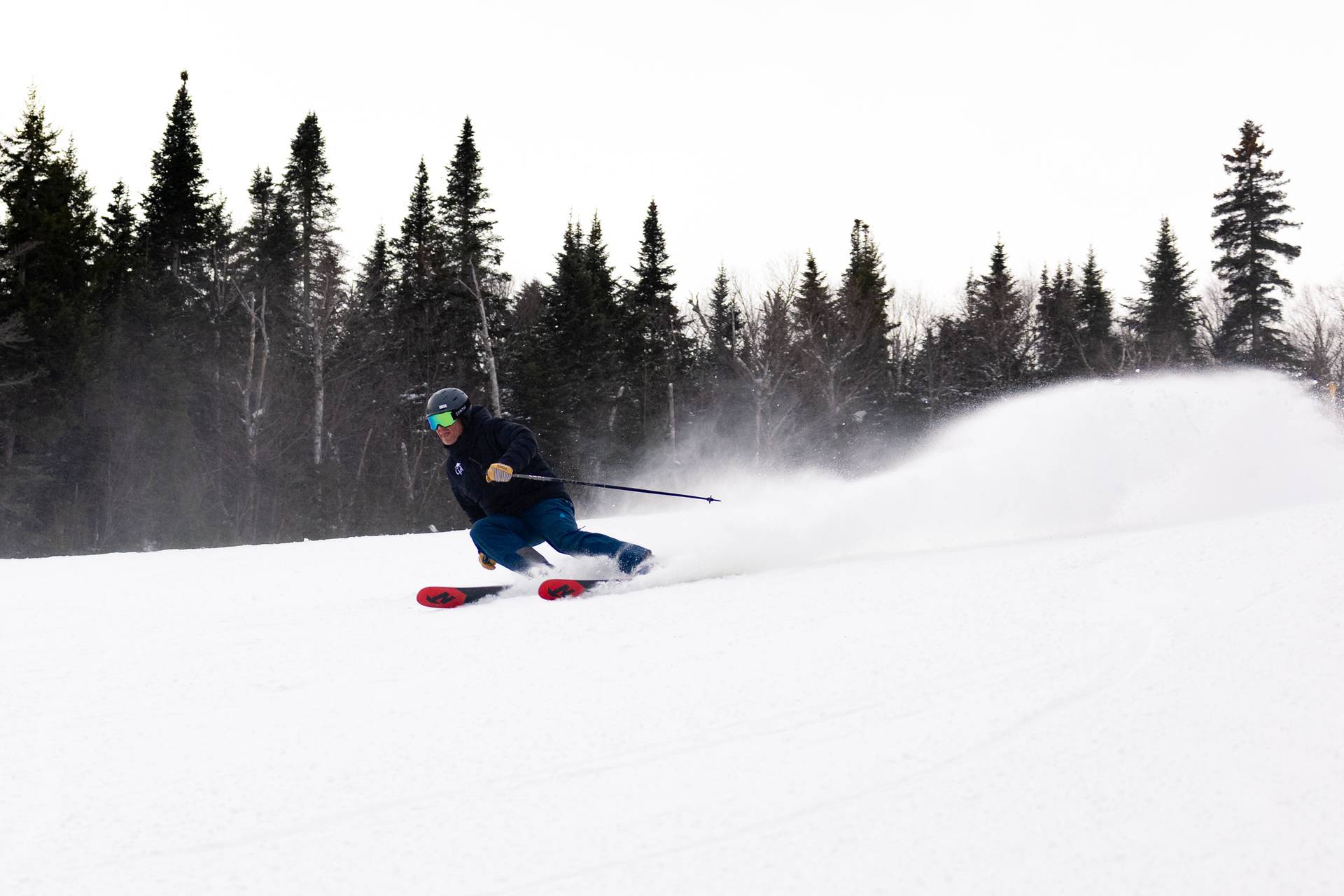 A skier on West Mountain makes a turn on a cloudy day