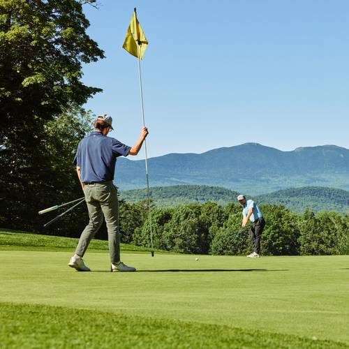 Golfers with mountain views