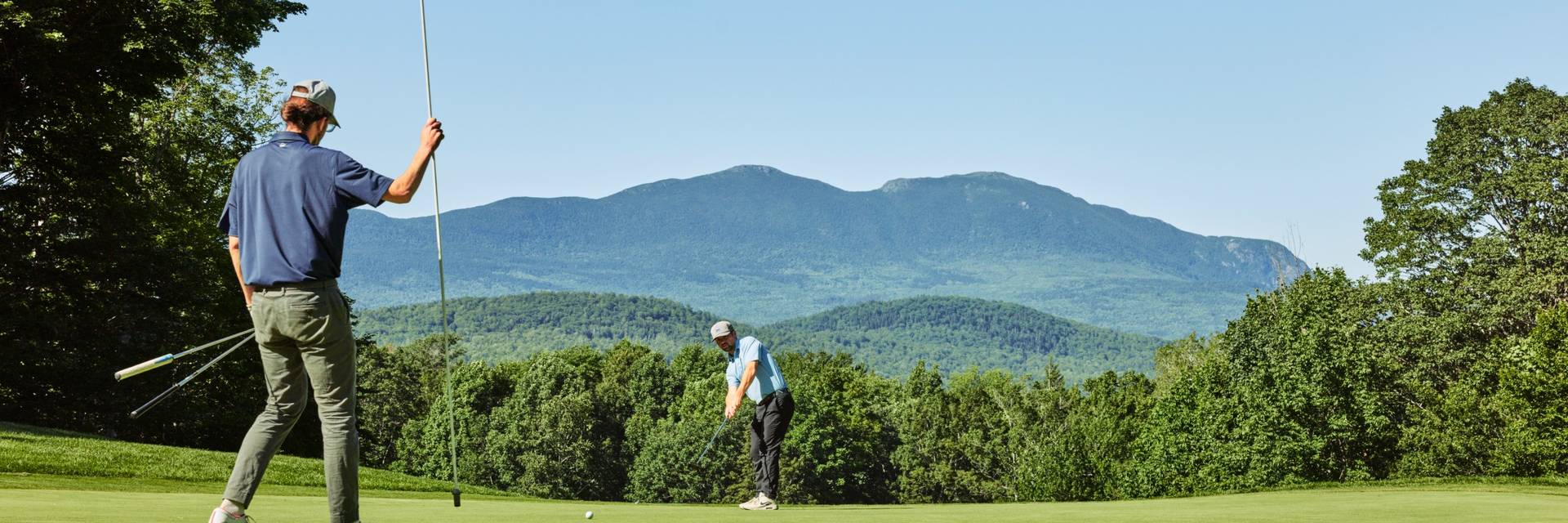 Golfers with mountain views