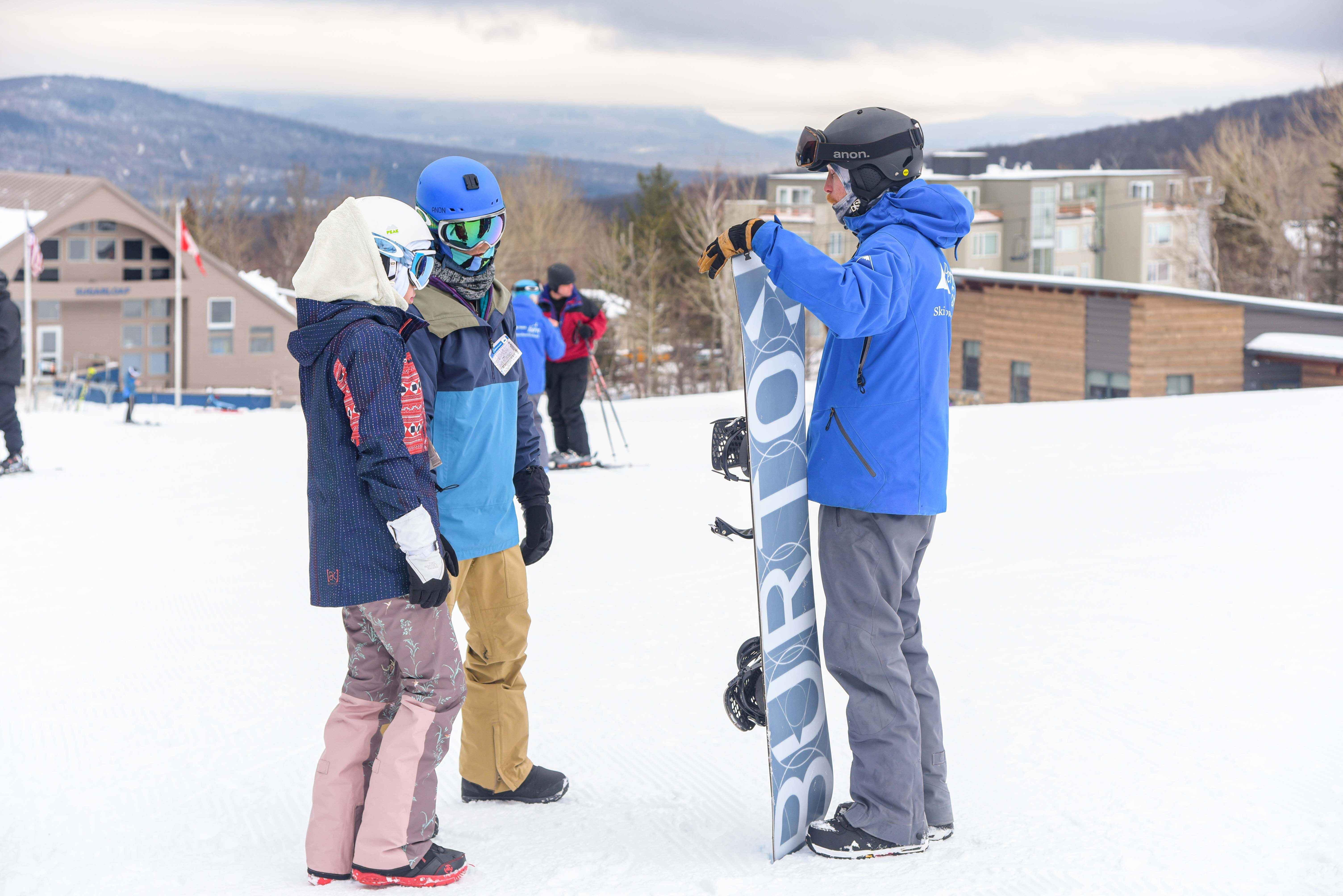 Snowboard instructor with adults