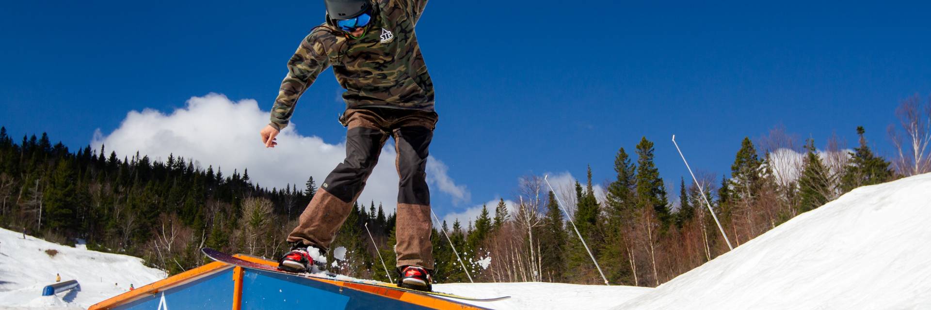 snowboarder sliding on rail