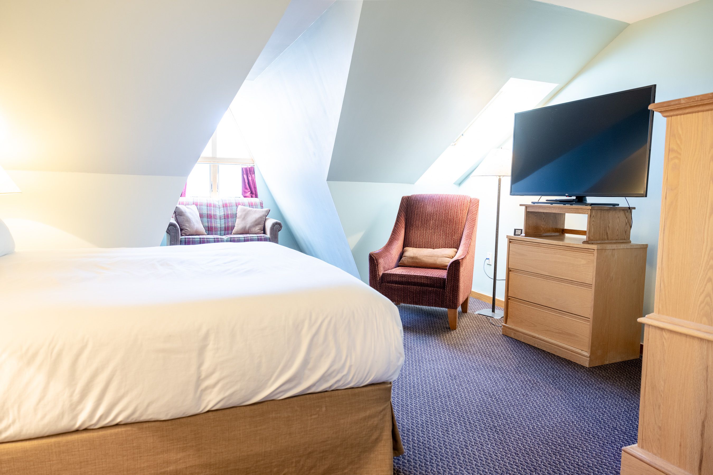 A hotel room with a big flatscreen tv for wind hold days 