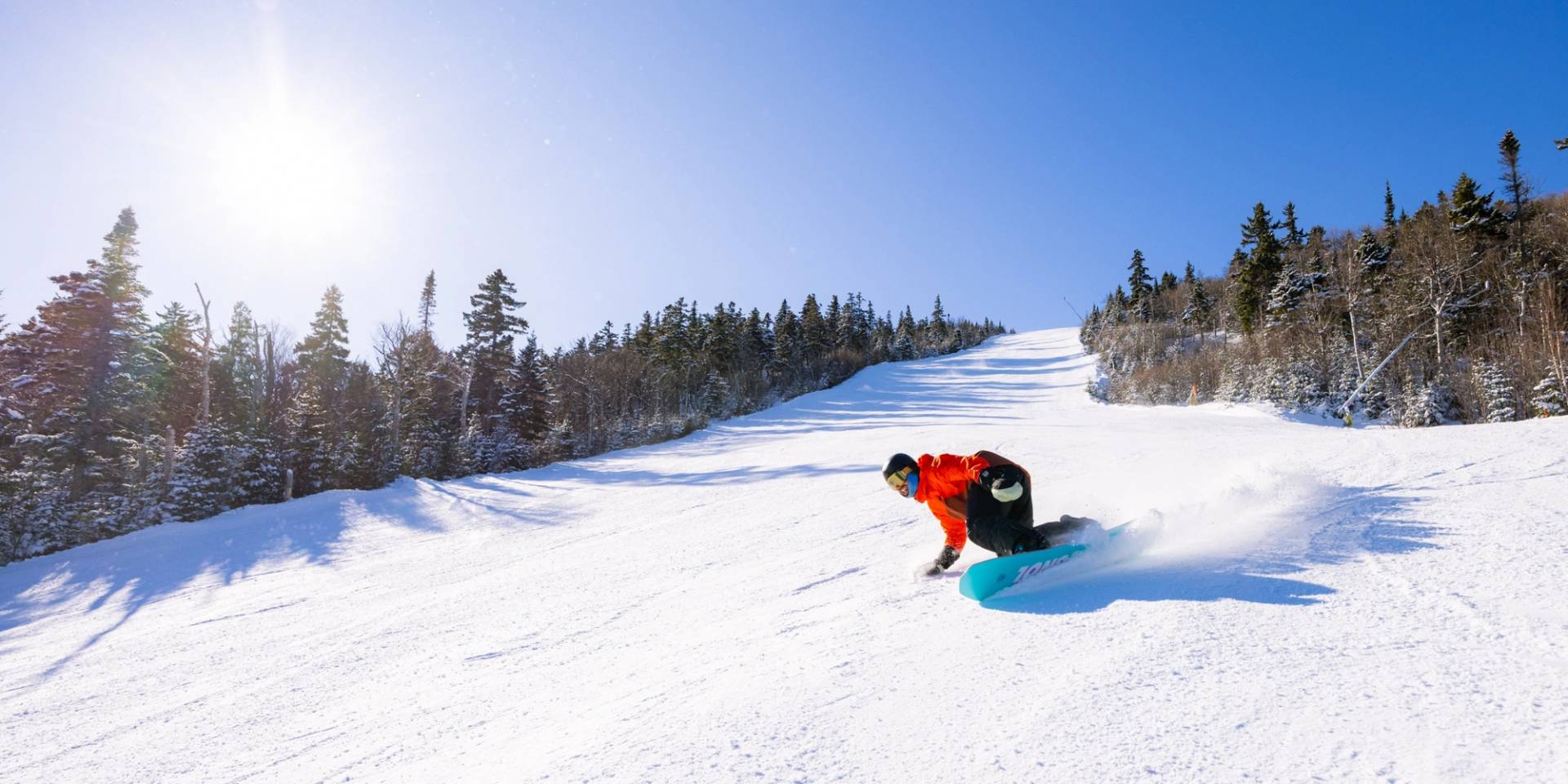 Snowboarder on groomed trail