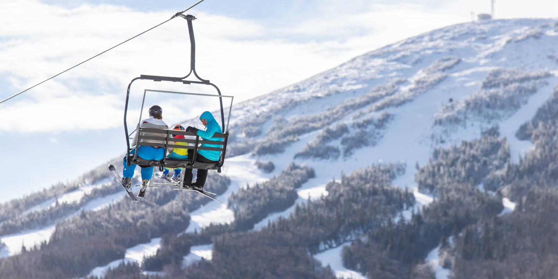 3 skiers on chairlift