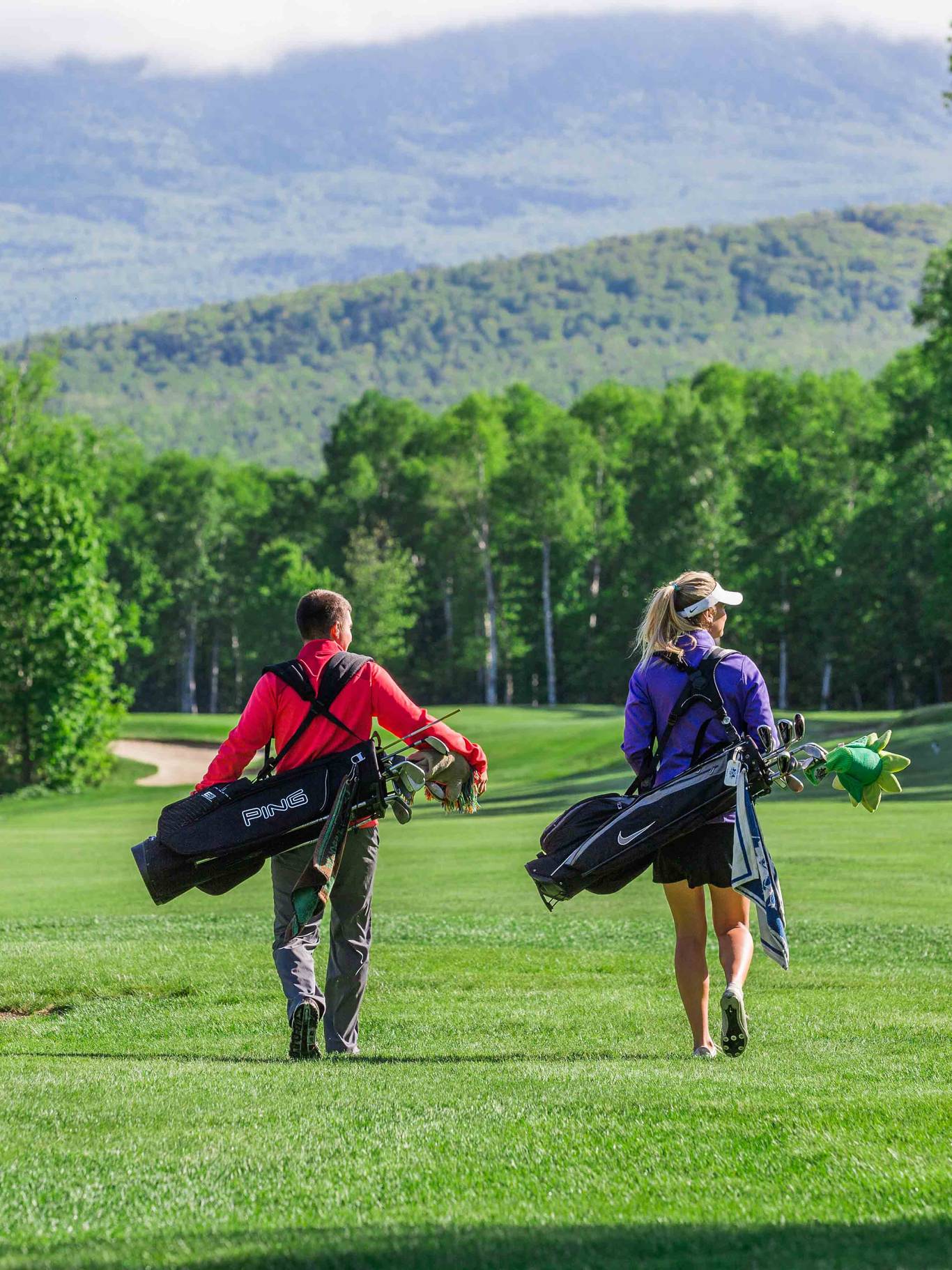 Golfer looking out over mountain vista