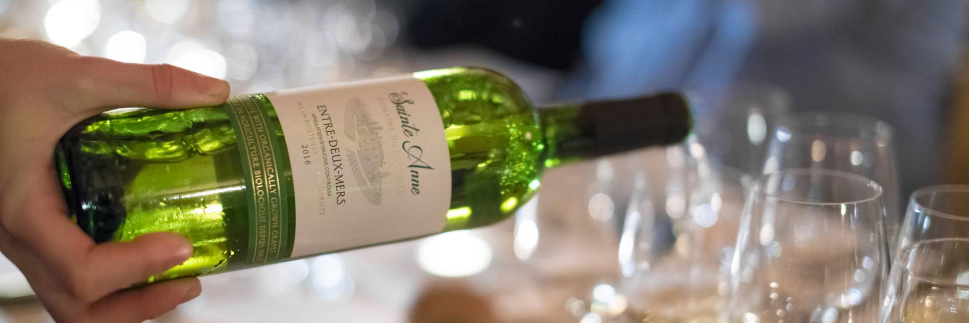 Server pouring wine into glass