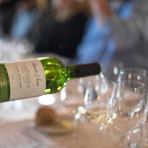 Server pouring wine into glass