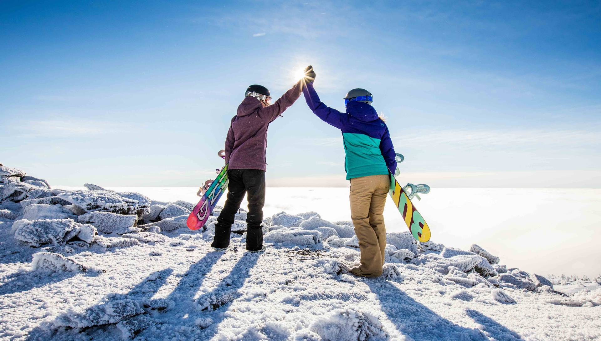 Snowboarders high fiving