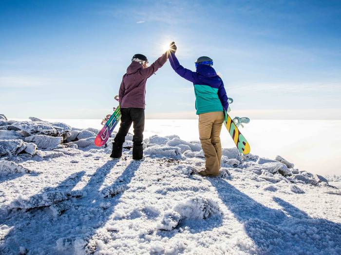 Snowboarders high five
