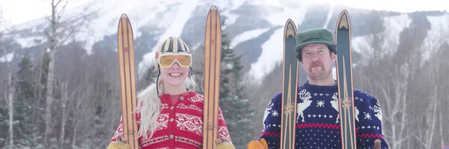 Male and female skier in vintage attire