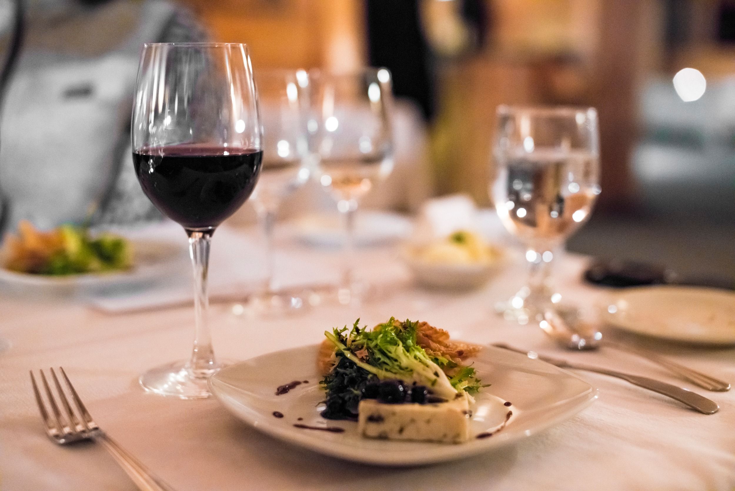 Plated food with a glass of red wine