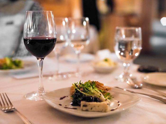 Plated food with a glass of red wine