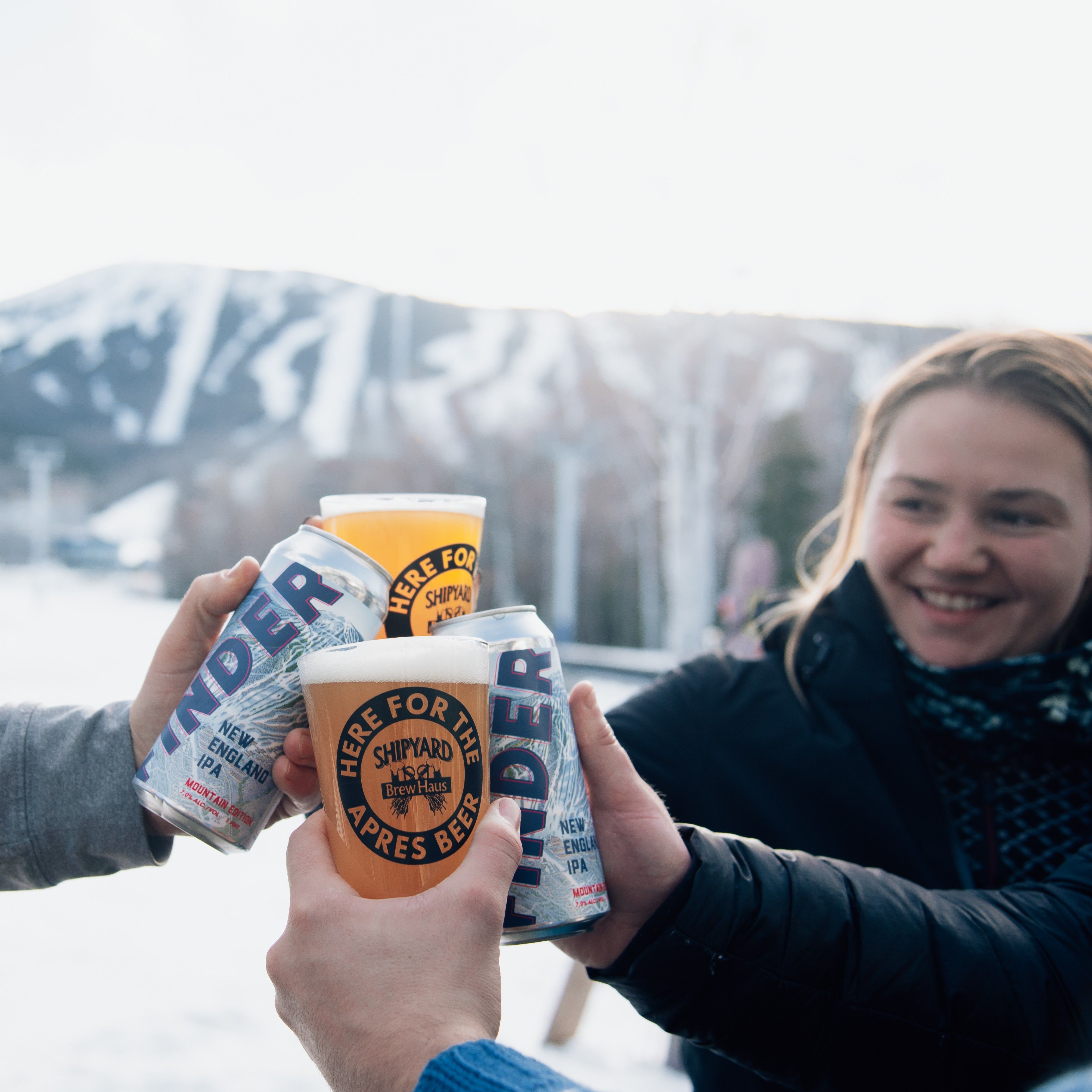 happy guest cheering Shipyard Beer in front of Sugarloaf Mountain