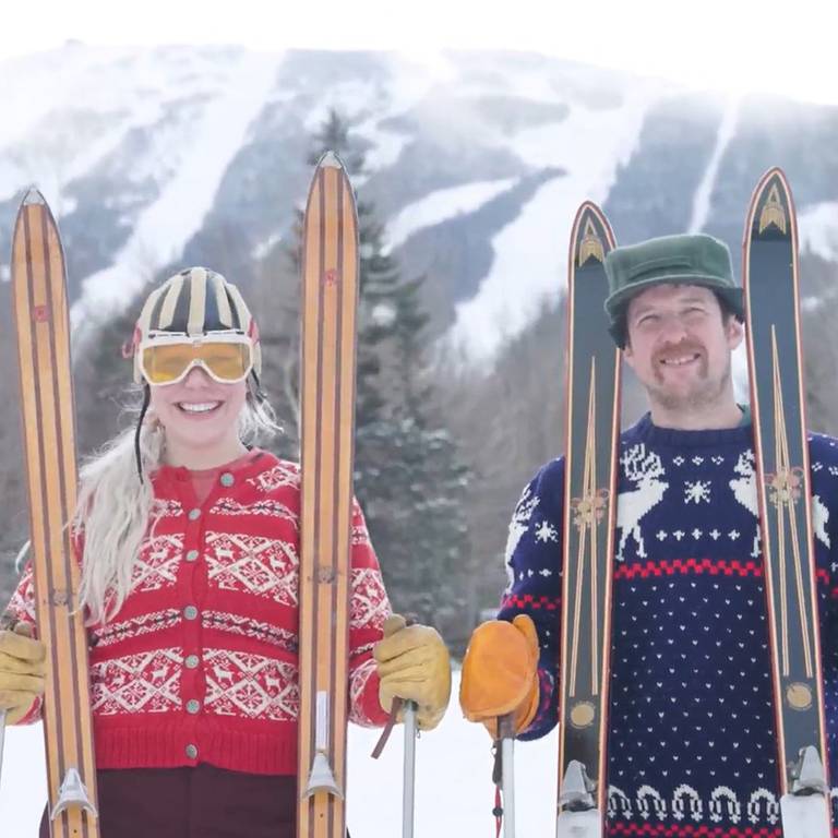 Vintage skiers with skis