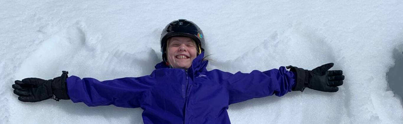 smiling girl making snow angel