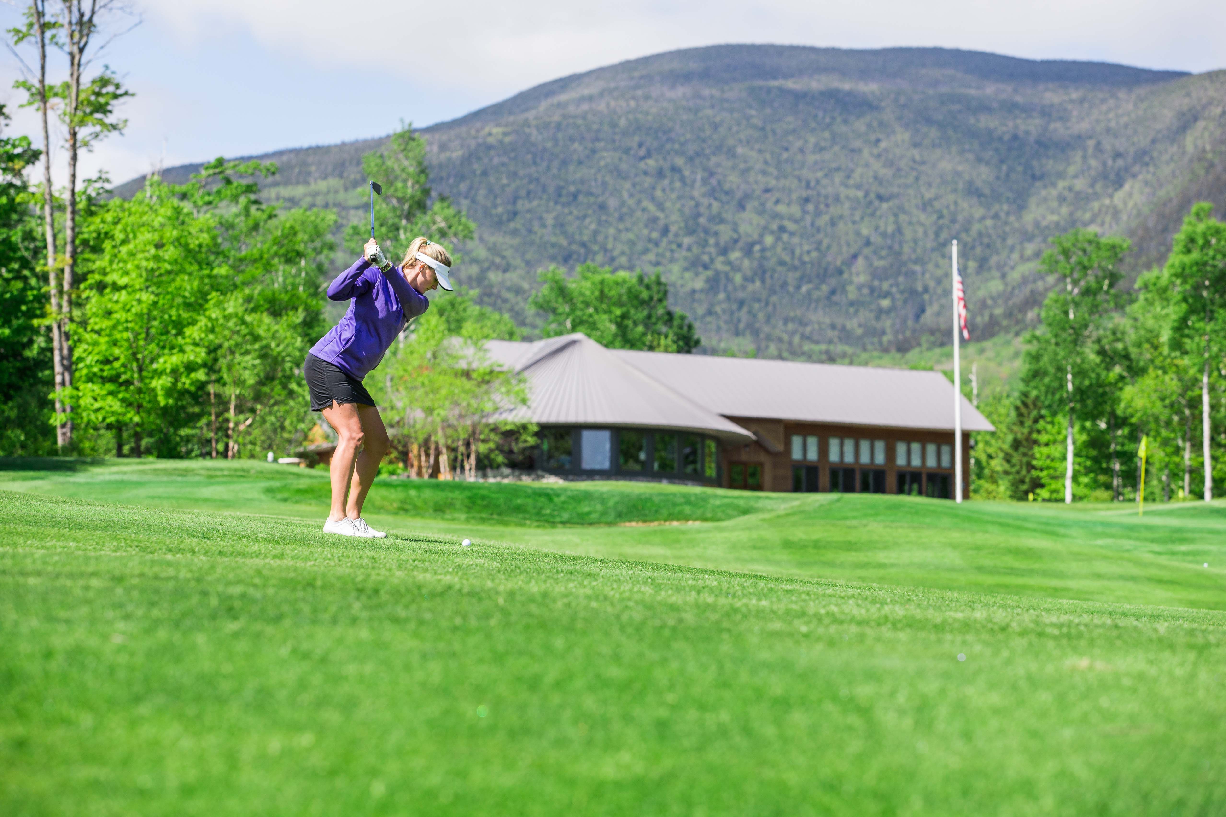 Female golfer mid swing