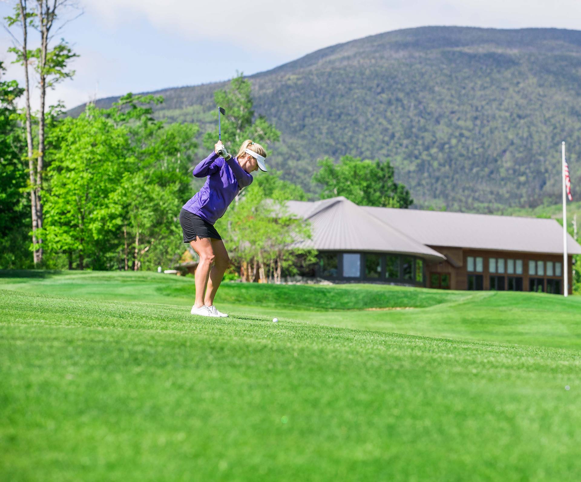 Female golfer mid swing