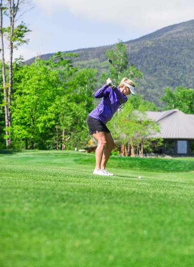 Female golfer mid swing