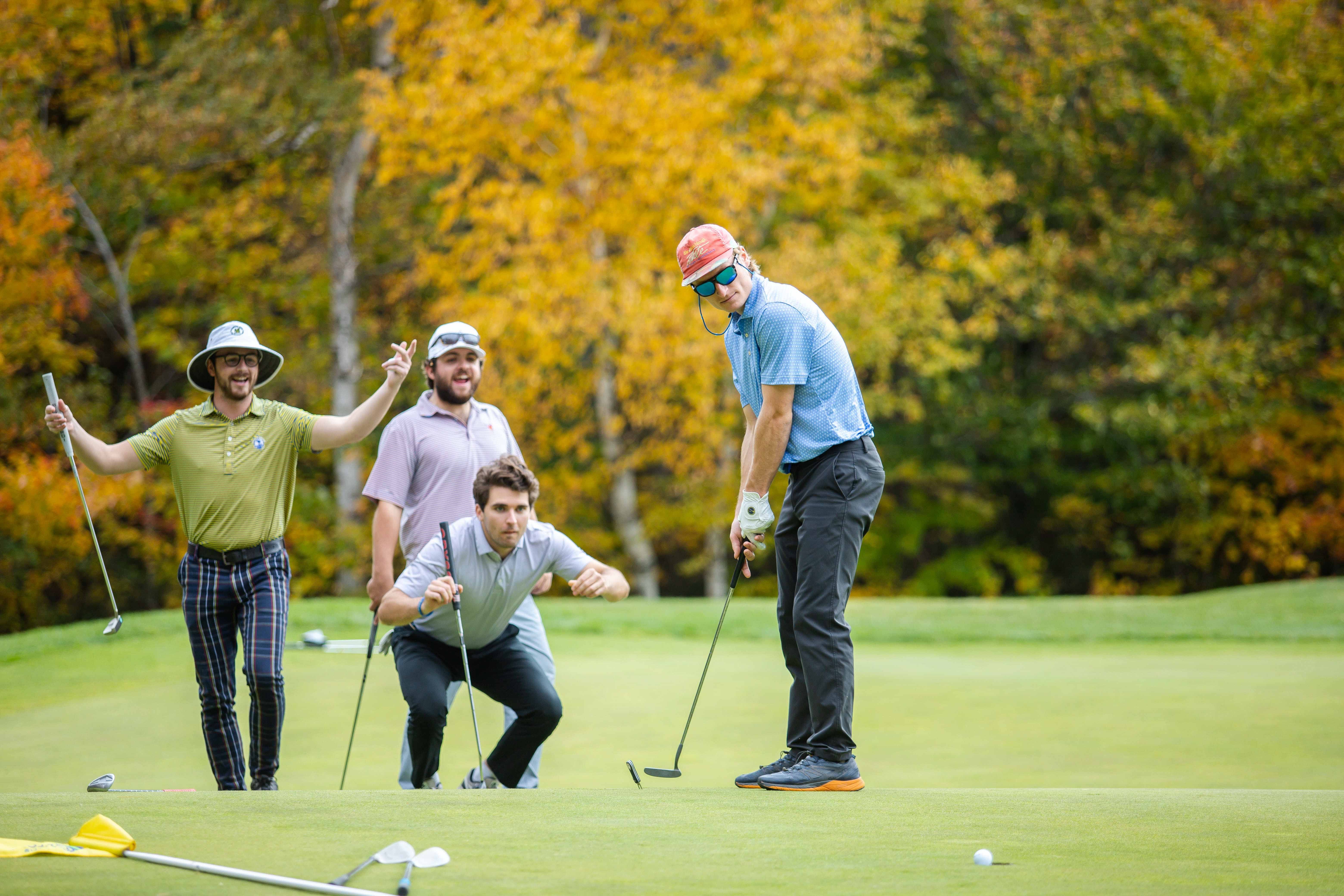 Golfers cheering on a putter