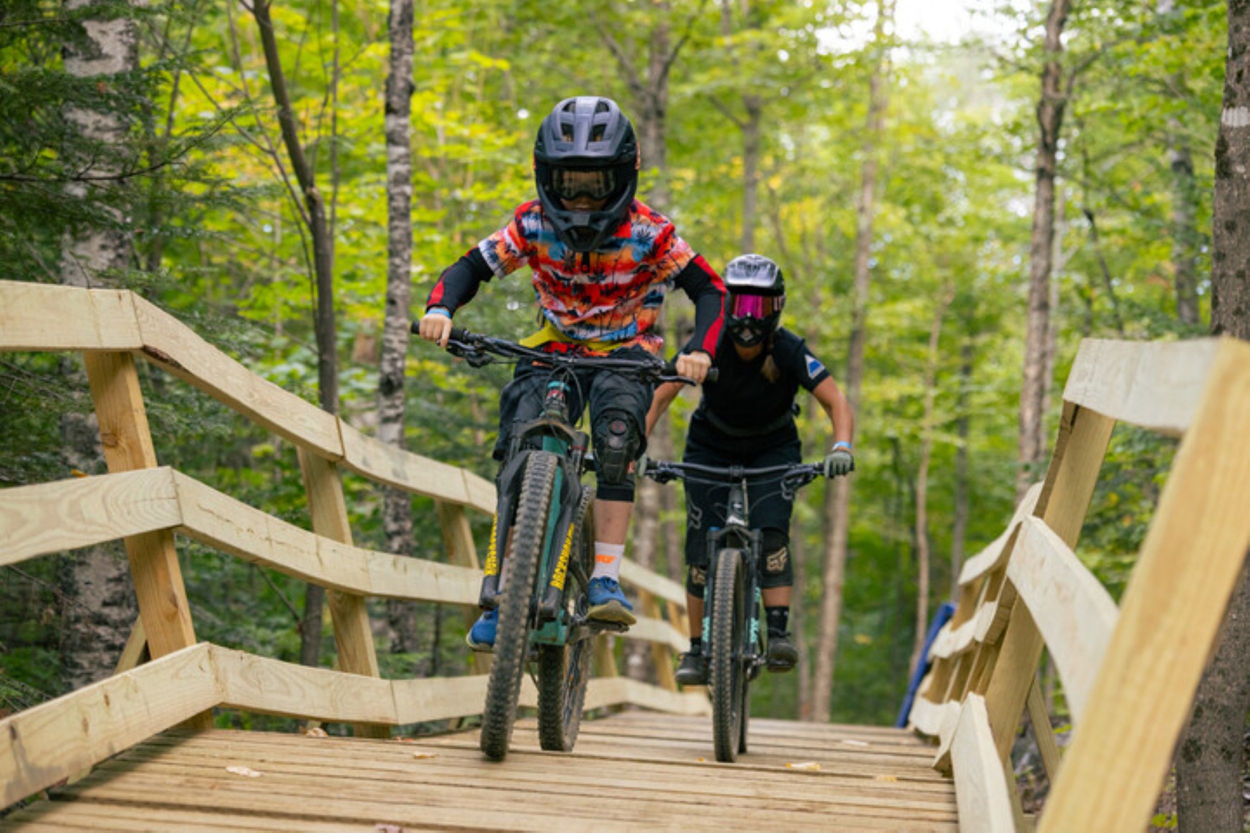 Two riders on bridge