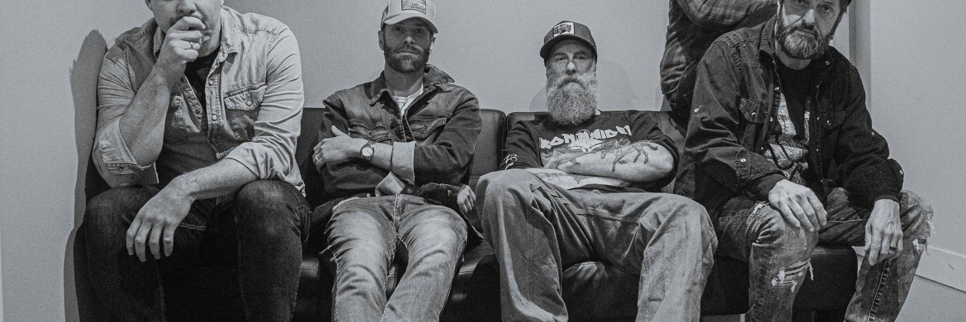 group of five band members posing