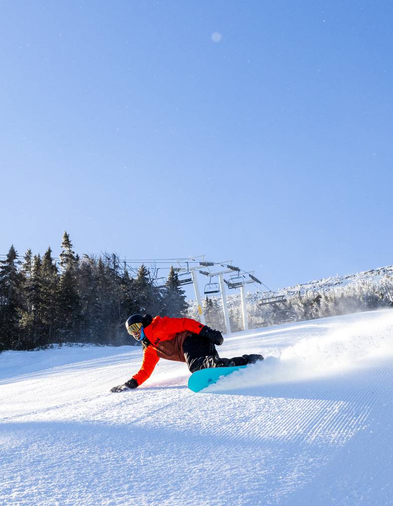 Snowboarder on groomed trail