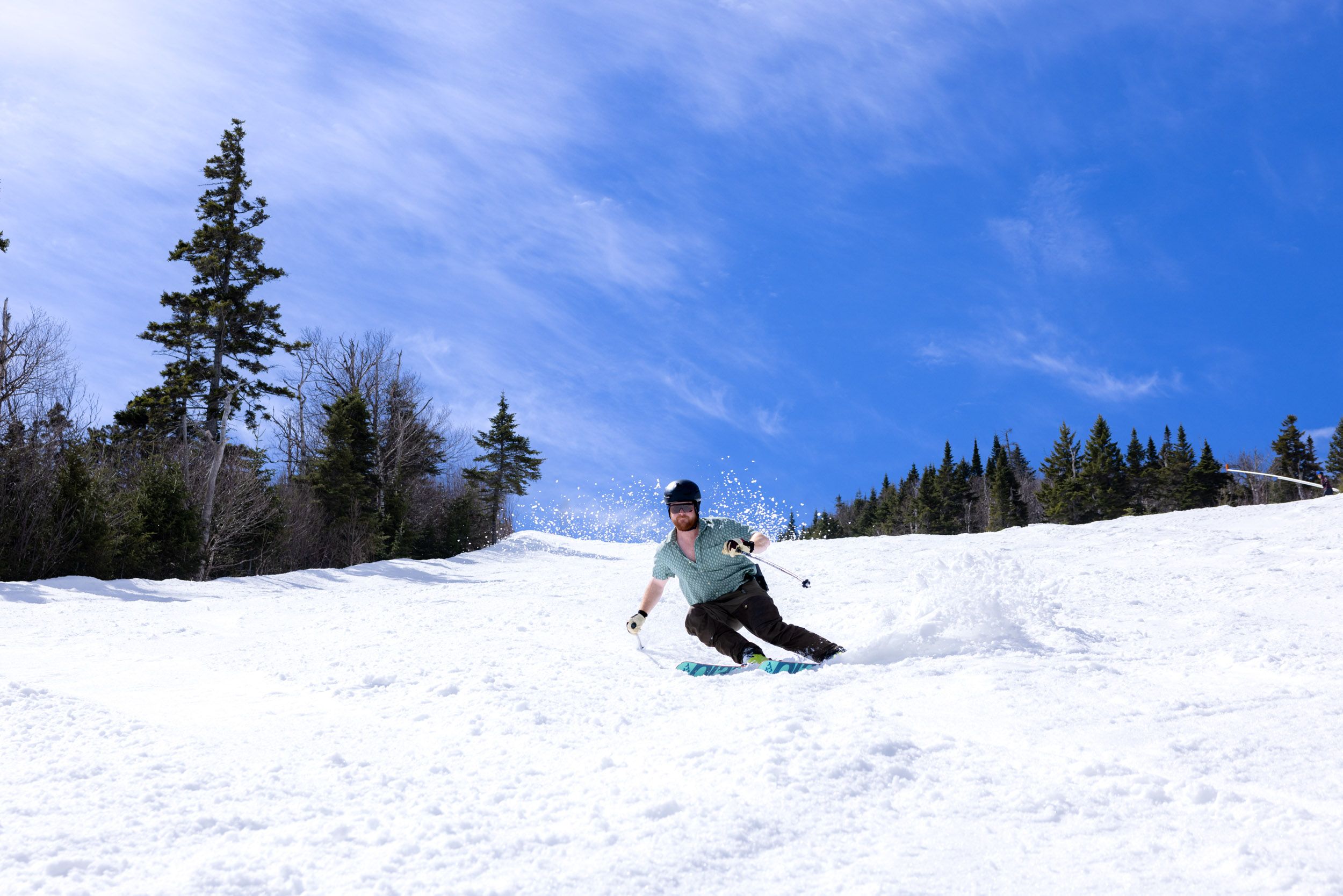 A skier under a blue sky