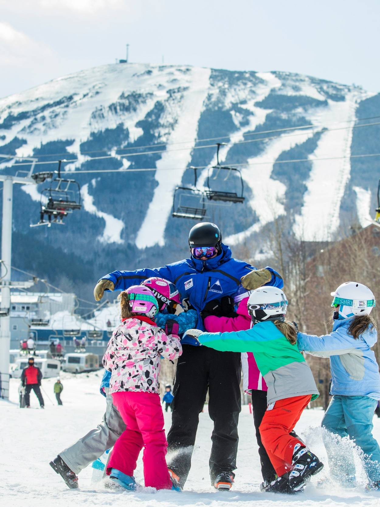 Excited kids expressing gratitude to their ski instructor