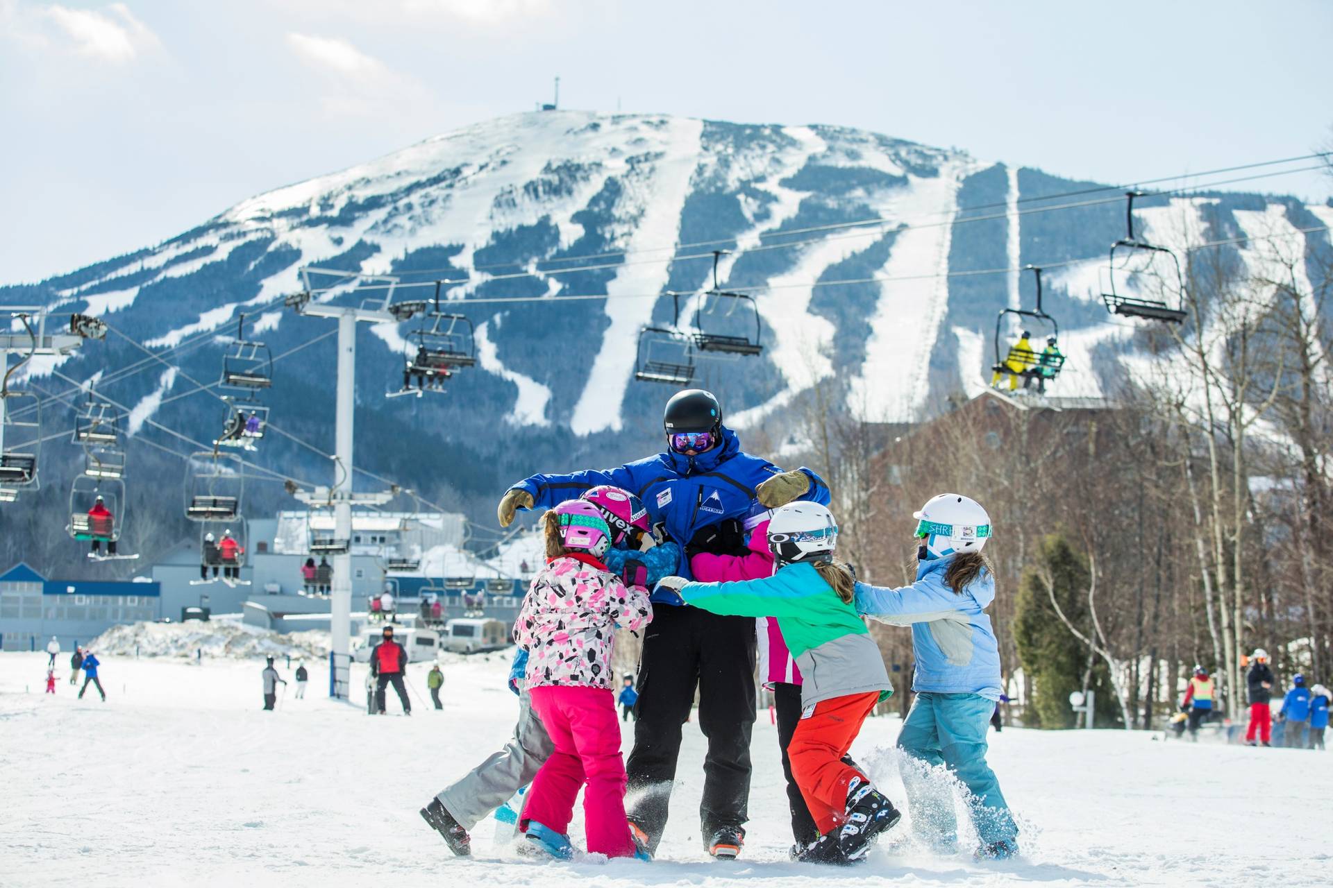 Ski instructor receiving a group hug