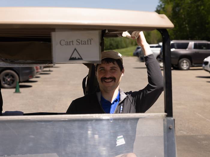 Team member in golf cart
