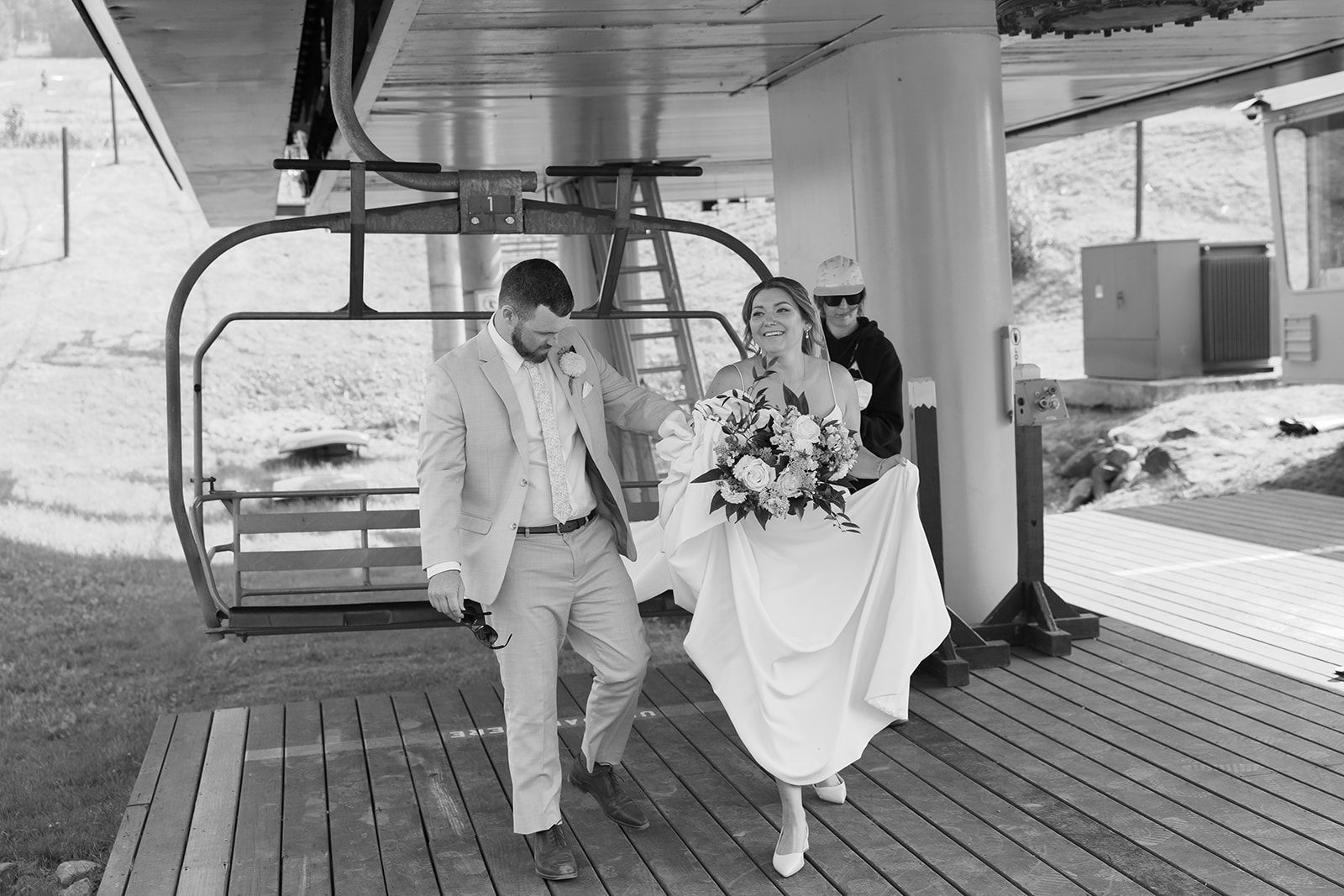 bride and groom unloading chairlift