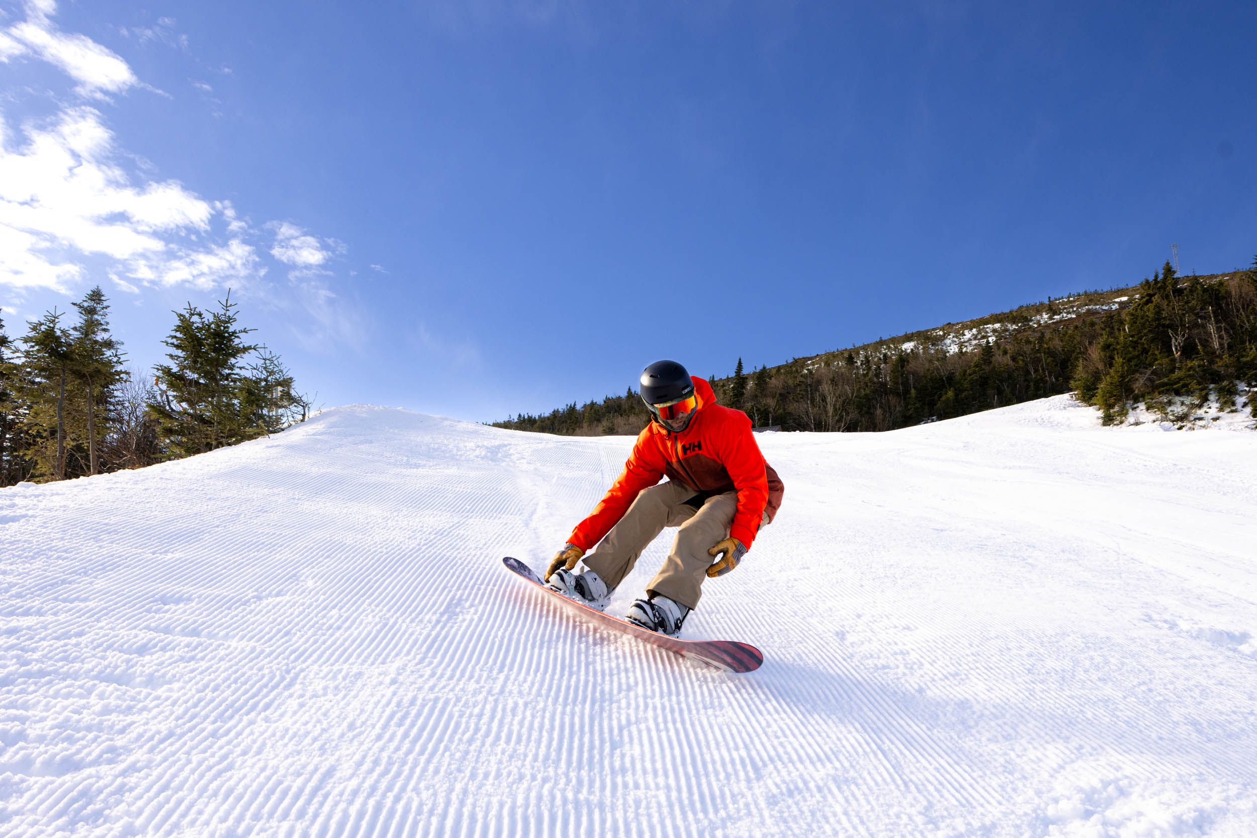 A snowboarder rips through cord