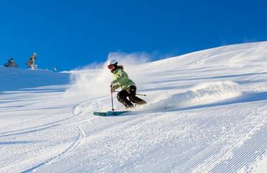Skier on groomer