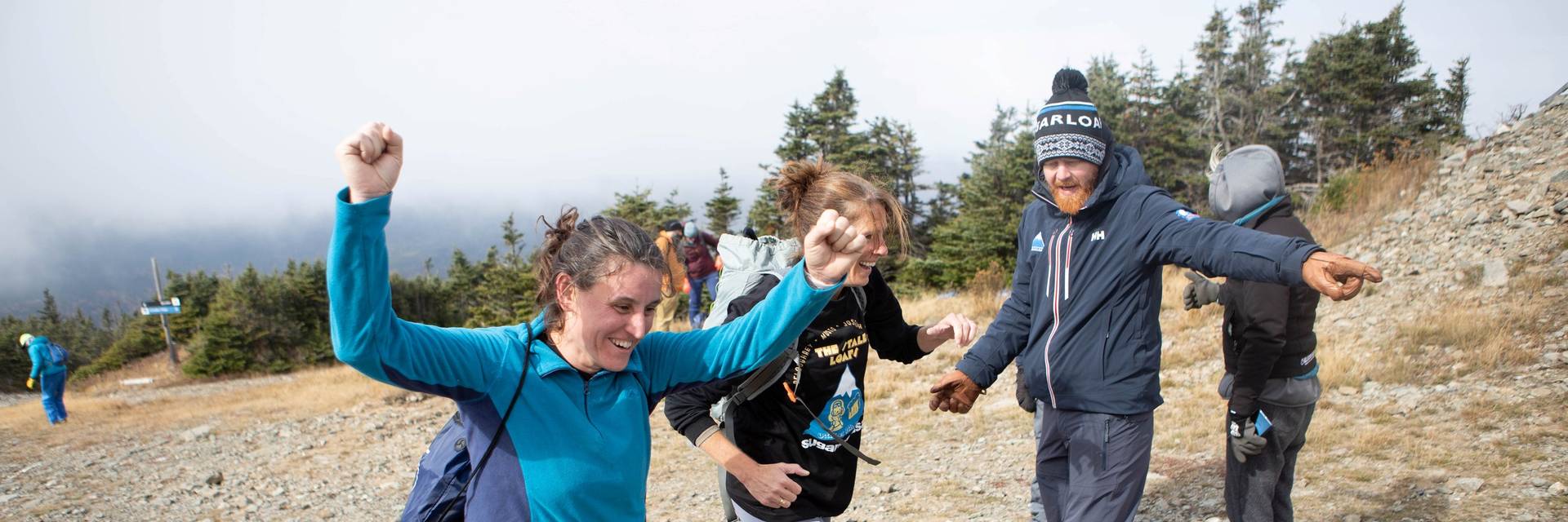 Runner reaches the finish line with arms overhead in victory