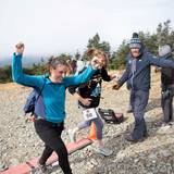 Runner reaches the finish line with arms overhead in victory