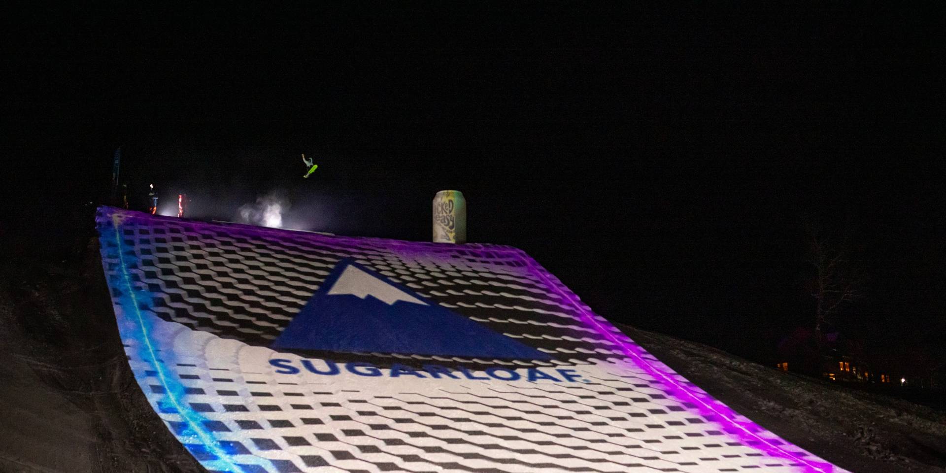 Skier on large illuminated jump