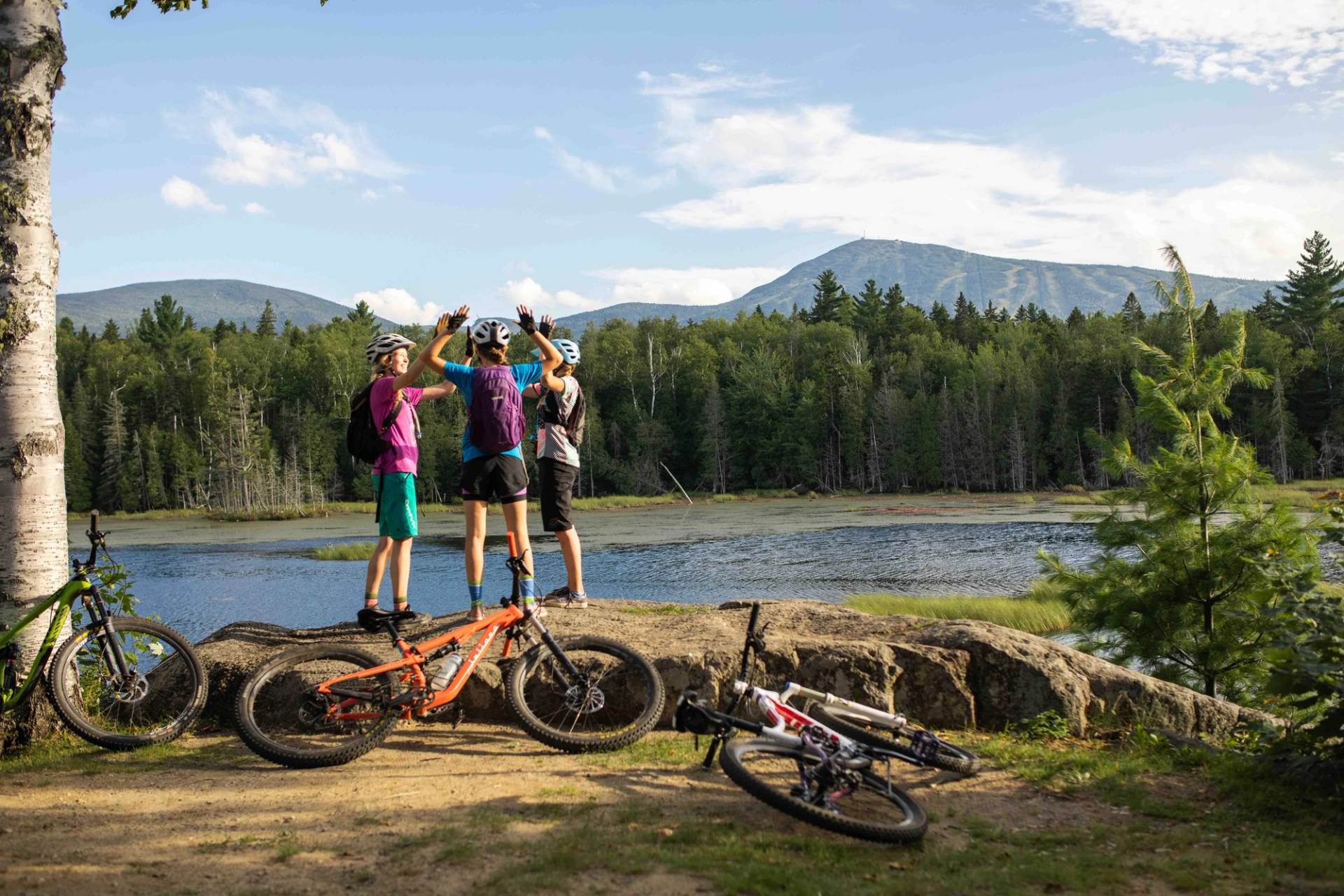 Mountian bikers high fiving