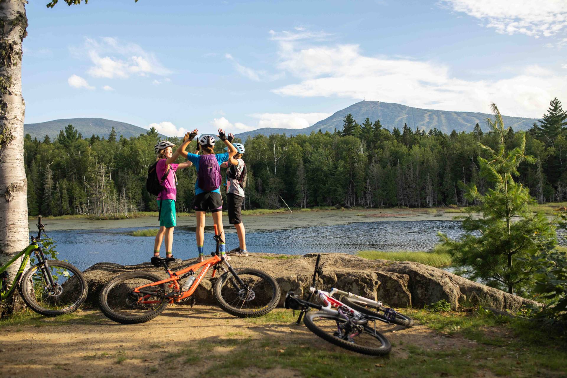 Mountain bikers high fiving at the Outdoor Center
