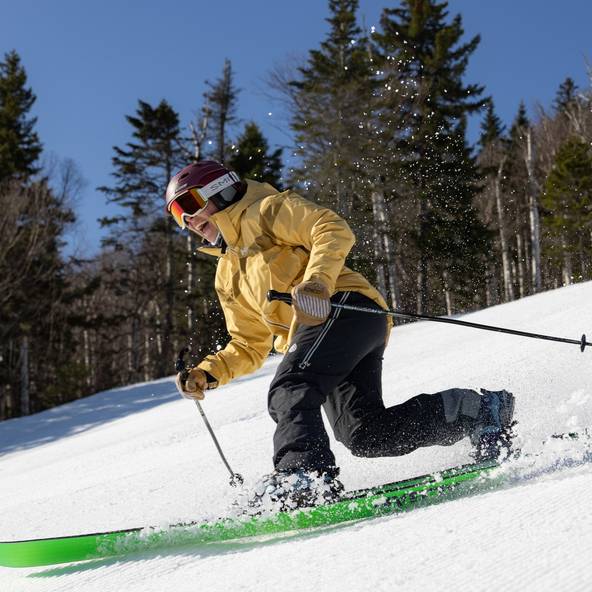Tele skier in yellow jacket