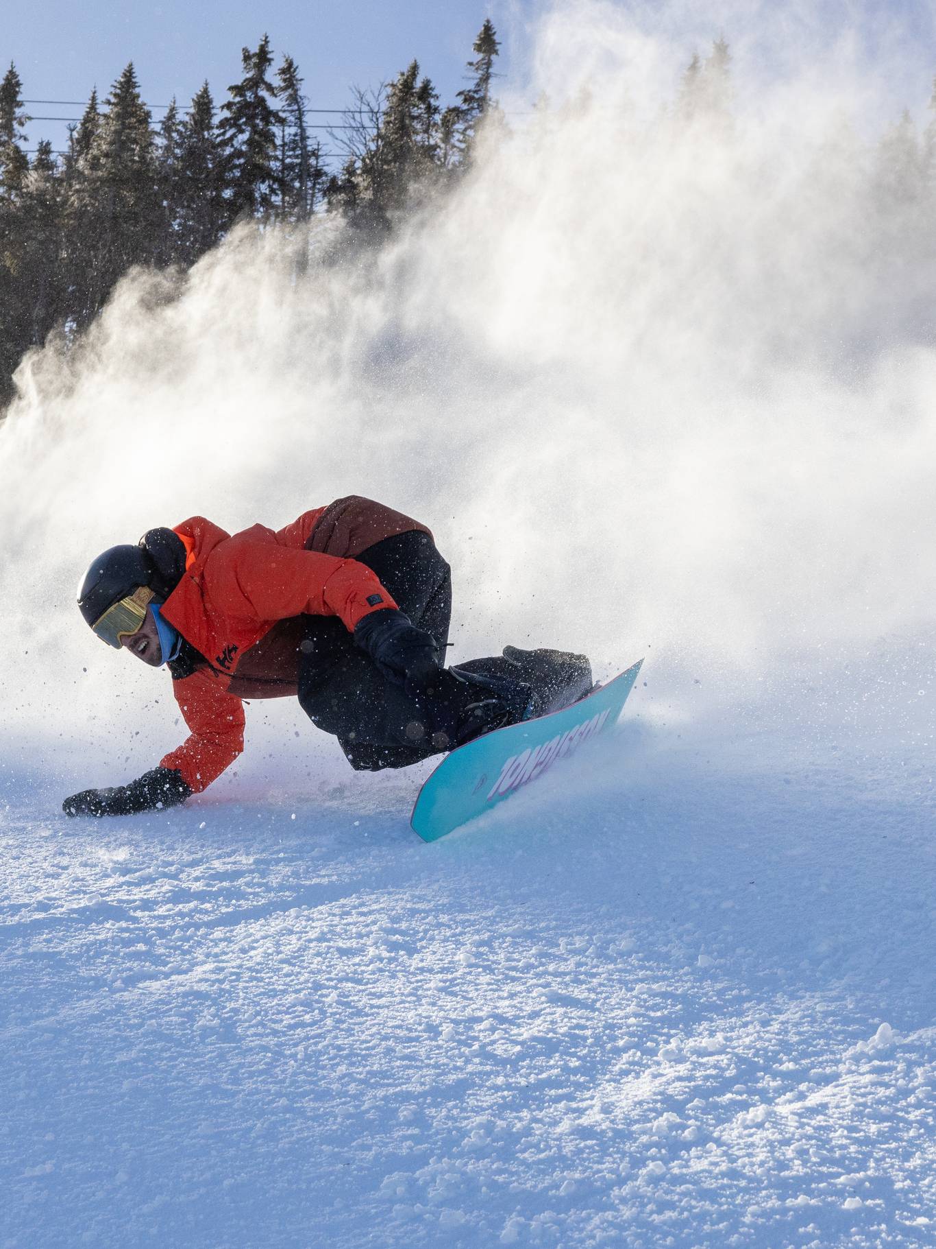 Male snowboarder on groomed trail