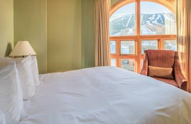 Hotel bed with view of mountain