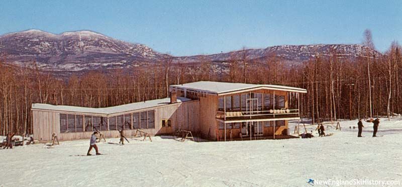 2 men sitting in snow