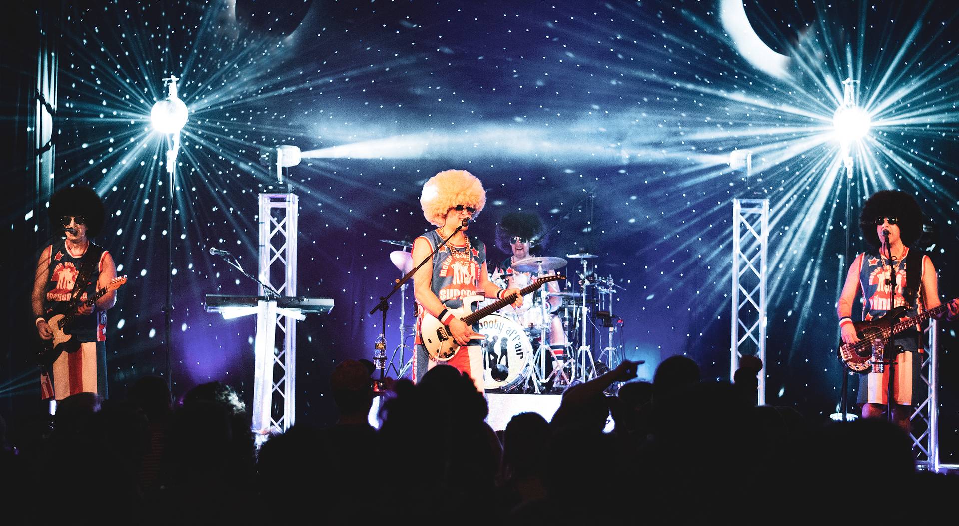 Moto Booty Affair band members on stage