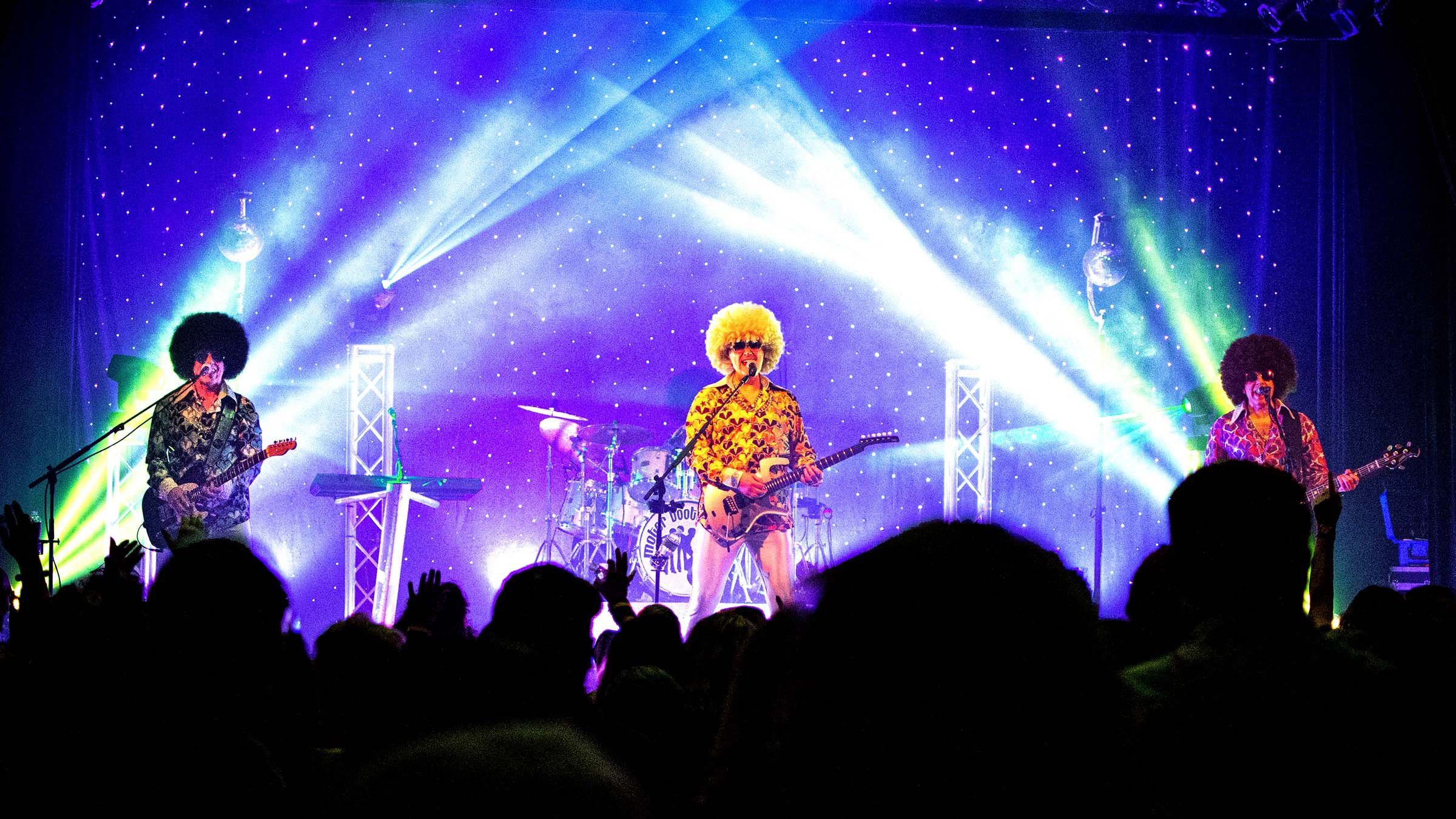 three band members on stage