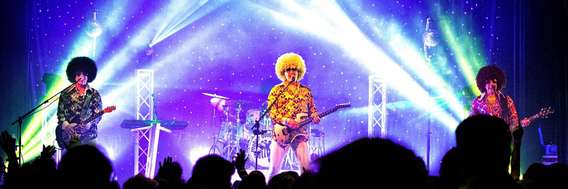 three band members on stage