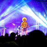 three band members on stage